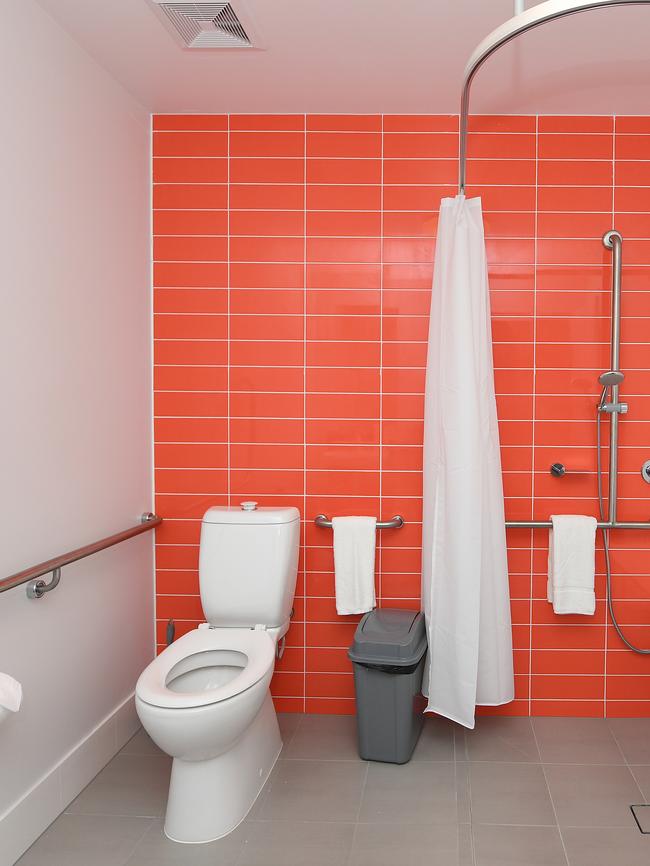 A shower and toilet are seen in an athletes accommodation