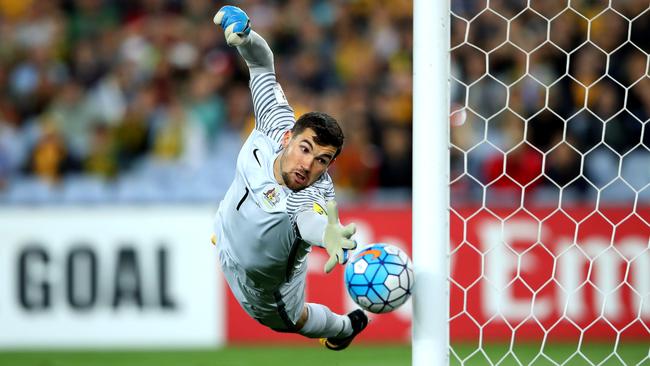 Mat Ryan watches the ball hit the post.