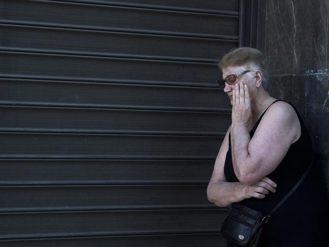 A woman waits outside a closed bank to receive her pension in Athens. Picture: Petros Giannakouris / AP