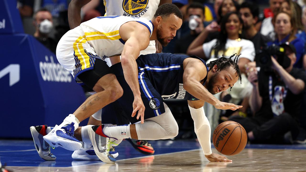 Jalen Brunson of the Dallas Mavericks fights for the ball against Stephen Curry. Picture: Tom Pennington