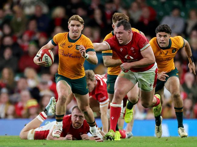 Tate McDermott of Australia runs with the ball after evading Tommy Reffell and Ryan Elias of Wales during the Autumn Nations Series 2024 match between Wales and Australia at the Principality Stadium on November 17, 2024 in Cardiff, Wales. Picture: Getty Images