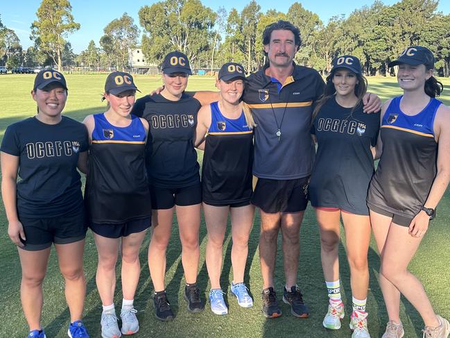 Old Carey women's football coach Ryan Dobson with his players at training. Picture: Supplied.