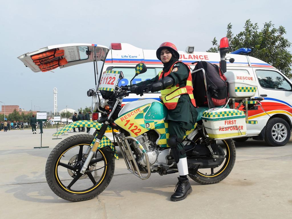 Pakistani first responder Samra Akram Zia with her motorcycle ambulance service during a passing out ceremony in Lahore. Picture: AFP
