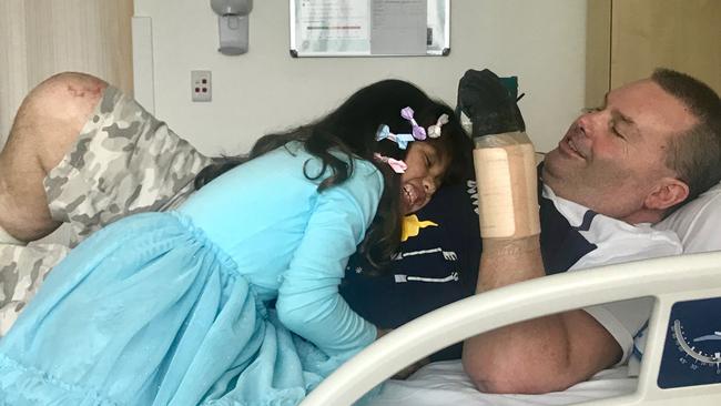 Jason 'Buddy' Miller at Northern Beaches Hospital with his daughter Jhayda, 7. His family say his love for his daughter has pulled him through. Picture: Supplied.