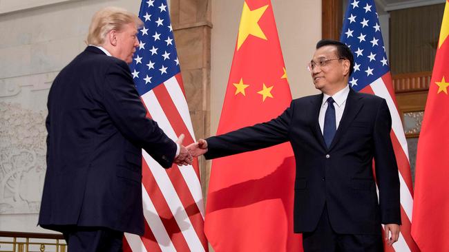 Donald Trump shakes hands with then Chinese premier Li Keqiang during a meeting at the Great Hall of the People in Beijing on November 9, 2017. Picture: AFP