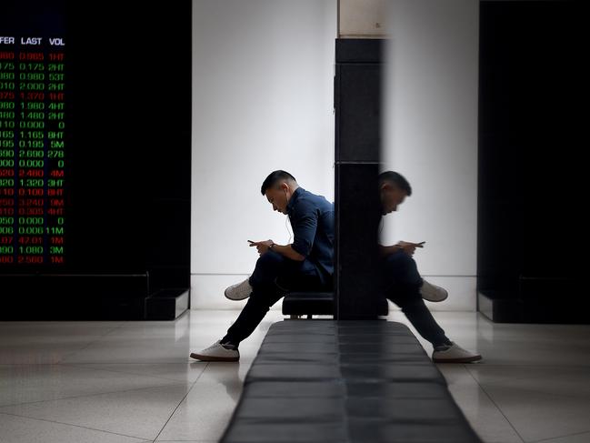 SYDNEY, AUSTRALIA - NCA NewsWire Photos AUGUST, 12, 2020: A man is seen on his phone at the Australian Stock Exchange (ASX) in Sydney. Picture: NCA NewsWire/Bianca De Marchi