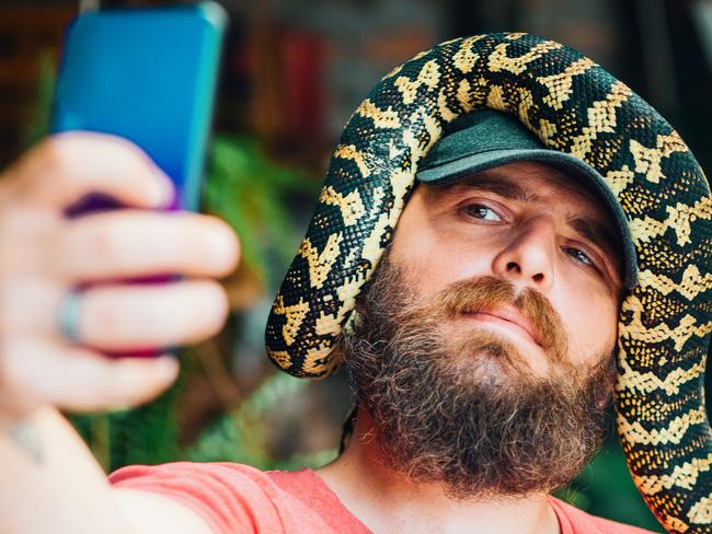 Taking a selfie with a snake is a thing.