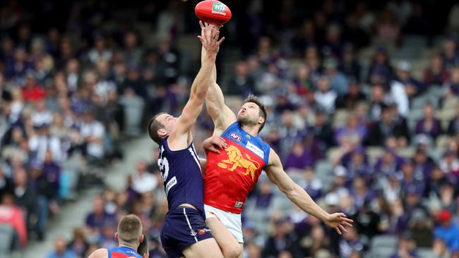 Stef Martin battles Michael Apeness at the centre bounce.