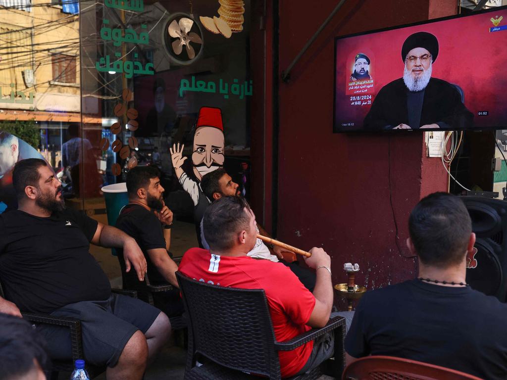 Lebanese men watch a televised address by Hezbollah chief Hassan Nasrallah at a cafe in the Shiyah neighbourhood of Beirut. Picture: AFP