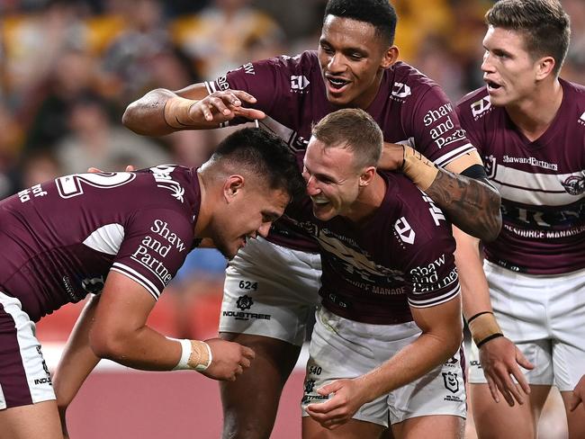 Josh Schuster celebrates with Daly Cherry-Evans after scoring a try for Manly in a big win over Brisbane during the NRL’s Magic Round. Picture: Bradley Kanaris/Getty Images