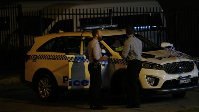 Detectives at the scene of the Newcastle stabbing at the Metro Service Station on Sandgate Road, Shortland. Picture by Peter Lorimer.