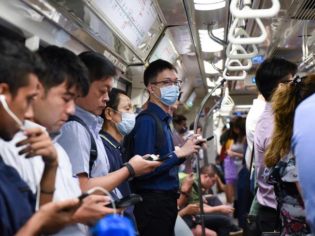 Commuters wear face masks on the Mass Rapid Transit train as a preventive measure against the COVID-19 coronavirus in Singapore. Picture: AFP