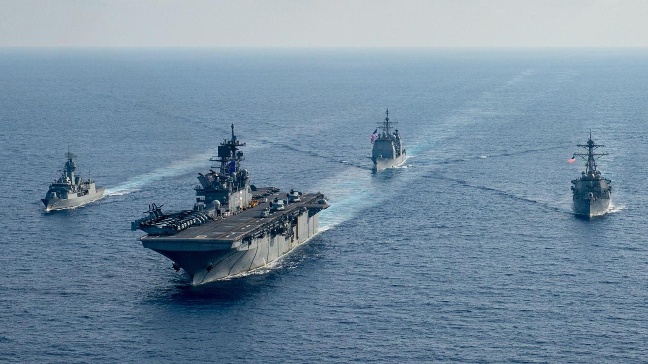 Royal Australian Navy helicopter frigate HMAS Parramatta conducts officer of the watch manoeuvres with amphibious assault ship USS America, guided-missile cruiser USS Bunker Hill and guided-missile destroyer USS Barry in the South China Sea earlier this year. Picture: Department of Defence