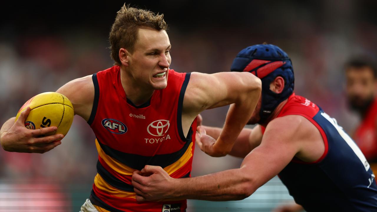 MELBOURNE, AUSTRALIA - JULY 23: Jordan Dawson of the Crows is tackled by Angus Brayshaw of the Demons during the round 19 AFL match between Melbourne Demons and Adelaide Crows at Melbourne Cricket Ground on July 23, 2023 in Melbourne, Australia. (Photo by Graham Denholm/AFL Photos via Getty Images)