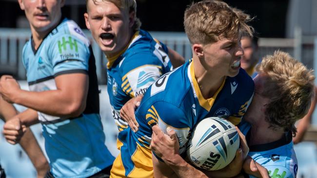 Ethan Sanders charges into a Shark. Picture: Monique Harmer
