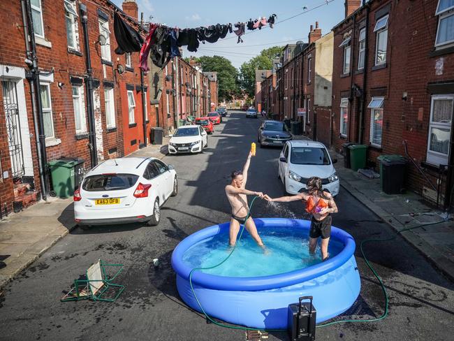 Residents take a dip in a paddling pool to cool off outside their home on July 19, 2022 in Leeds, United Kingdom, as the mercury soared past 40C. Picture: Christopher Furlong/Getty Images