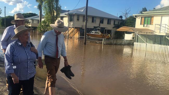 Joyce removes his boots to walk the streets of flood-ravaged Source: Twitter