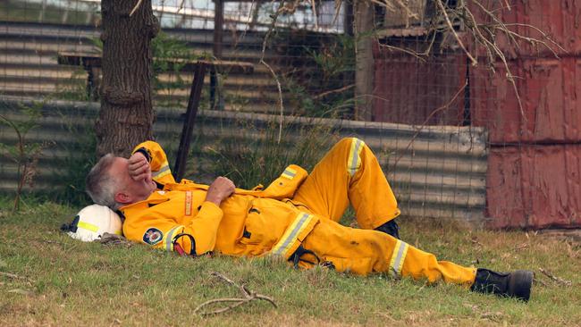 One RFS firefighter takes a well-deserved rest during a 12-hour shift last Tuesday. Picture: Gary Ramage.