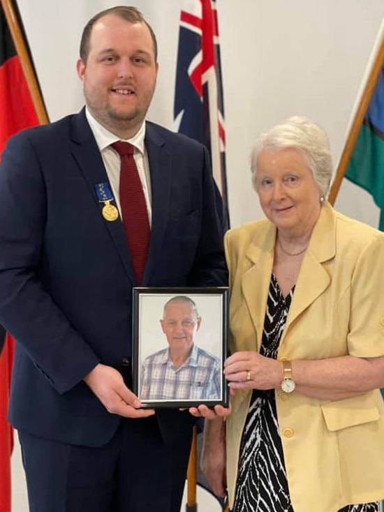 The late Ernest John Maltby's medal of the Order of Australia was accepted by Nicholas Tatnell, pictured with Mrs Margaret Maltby. Photo: Governor of Queensland.