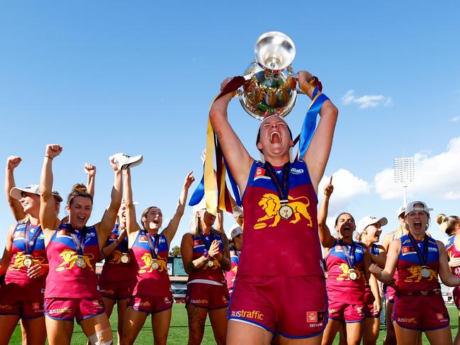 MELBOURNE, AUSTRALIA - DECEMBER 03: Dakota Davidson of the Lions celebrates with the premiership cup during the 2023 AFLW Grand Final match between The North Melbourne Tasmanian Kangaroos and The Brisbane Lions at IKON Park on December 03, 2023 in Melbourne, Australia. (Photo by Dylan Burns/AFL Photos via Getty Images)