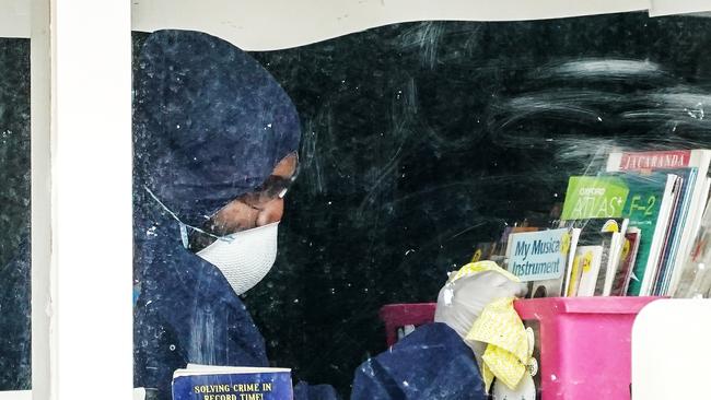 A cleaner is seen inside of a classroom at Meadowglen Primary School in Melbourne. Picture: AAP