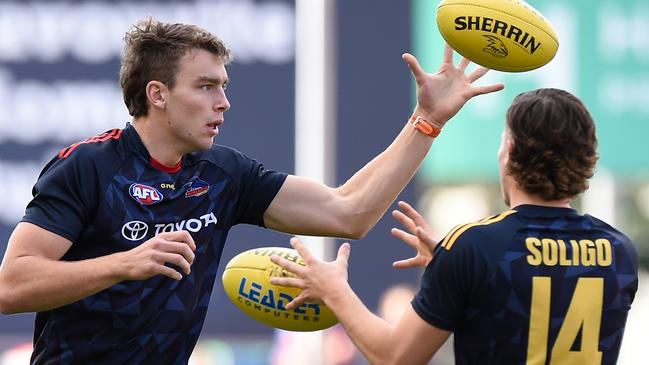 Riley Thilthorpe (left) warming up before Sunday’s game. Picture: Matt Roberts/AFL Photos/Getty Images