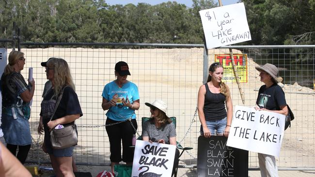 Black Swan Lake protest at Bundall goes to another level, with protesters chaining themselves to the fence and then getting themselves arrested after running onto the worksite and stopping the trucks. Police inform protesters of the situation. Picture Glenn Hampson