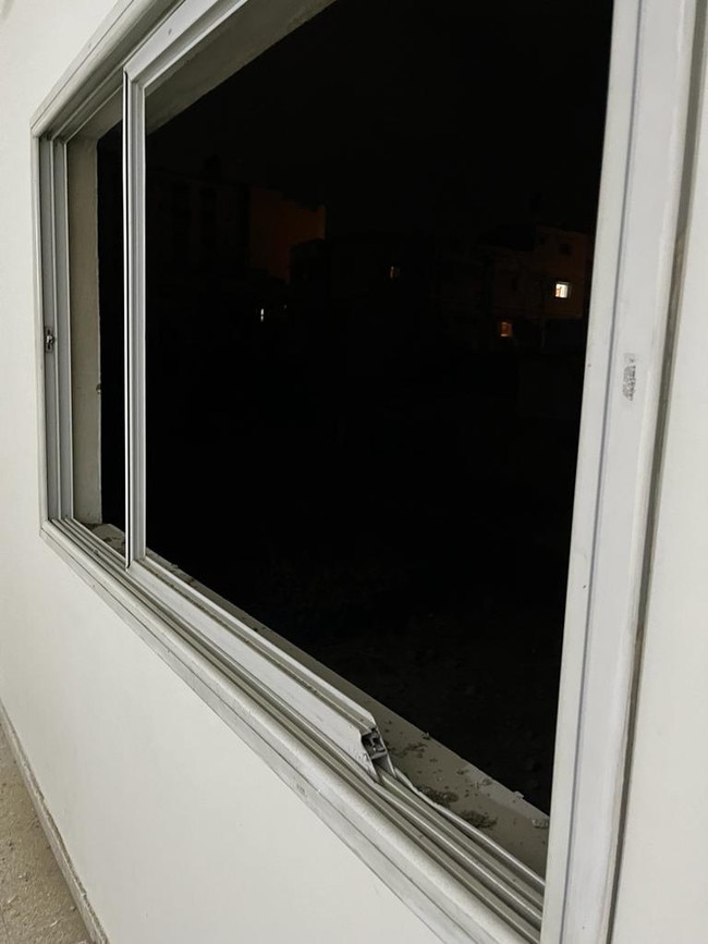 Damage to the window from nearby shelling.