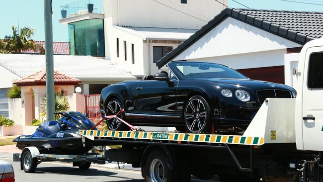 A police raid at Andrea Court, Broadbeach Waters resulted in 2 people being arrested, 2 cars, a jet ski and a motorbike being seized. Photo: Kit Wise