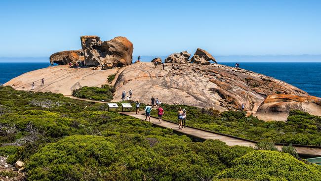 People walk up to Remarkable Rocks on Kangaroo Island.