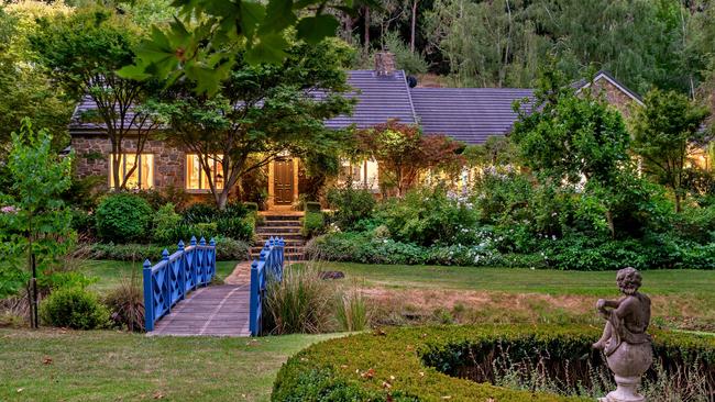 A blue bridge adds a nice touch to this home’s garden.