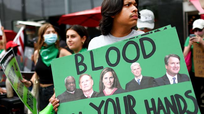 An abortion-rights activist holds a sign depicting Supreme Court Justices Clarence Thomas, Samuel A. Alito, Jr., Amy Coney Barrett, Neil M. Gorsuch, and Brett M. Kavanaugh during a demonstration outside a Planned Parenthood clinic. Picture: Mario Tama/Getty Images/AFP