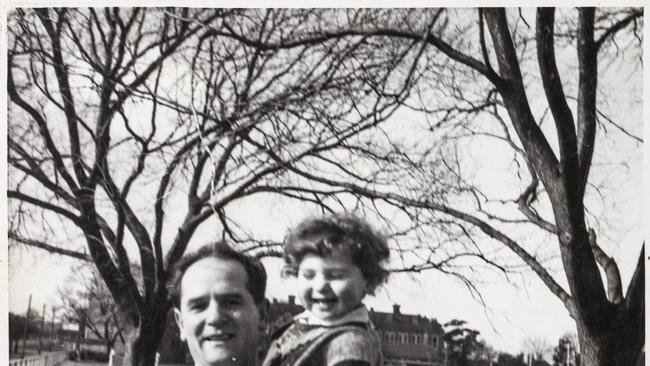 Boris holding toddler in trees.