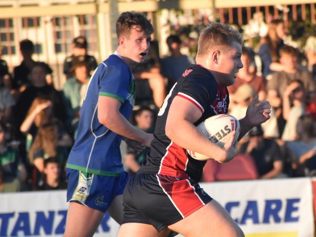 Emmaus College back rower Josh Nilon makes a barnstorming run.
