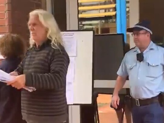 John Anderson being escorted from the Byron Shire Council chambers in Mullumbimby during the April 2021 ordinary meeting. Picture: Liana Boss