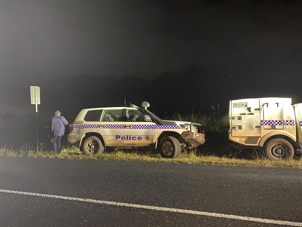 Police search along Commissioners Flat Road at Peachester for the missing plane.