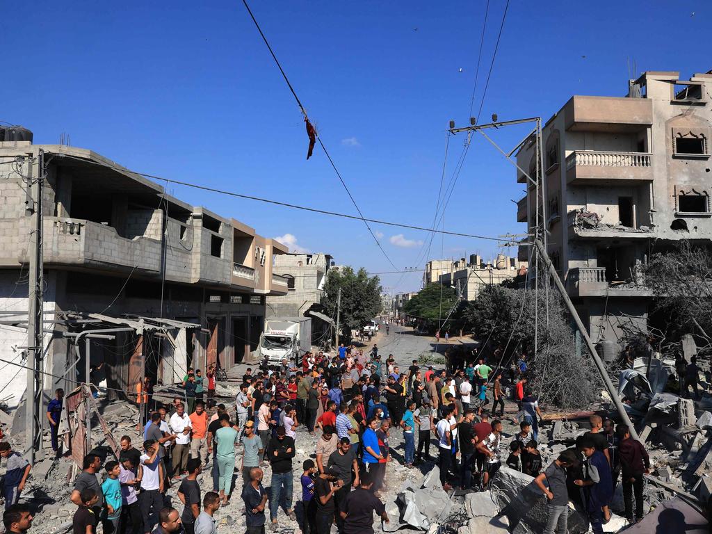 Palestinians gather at the site of a collapsed and damaged buildings following an Israeli airstrike in Rafah, in the southern of Gaza Strip. Picture: AFP