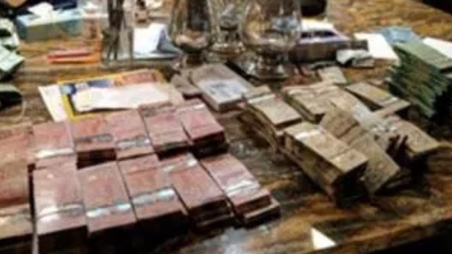 Money stacked on Cotten’s kitchen table. Picture: Ontario Securities Commission