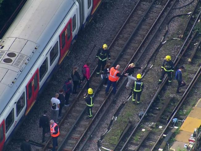 In this aerial image made from video, emergency workers help people to disembark a train near the Parsons Green Underground Station after an explosion in London. Picture: AP