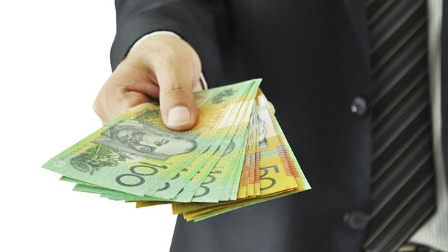 Businessman giving money — Australian dollars