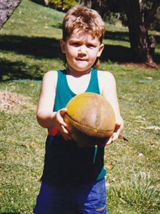 Dustin Martin with a footy aged 3.