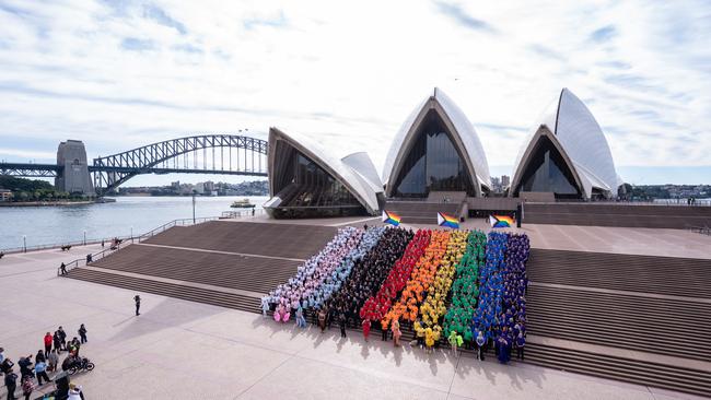 1,000 Sydneysiders united on the steps of the Sydney Opera House to form a giant Progress Flag to launch Sydney WorldPride 2023 and commemorate the 44th anniversary of the first Sydney Gay and Lesbian Mardi Gras. Picture: James D. Morgan/Getty Images