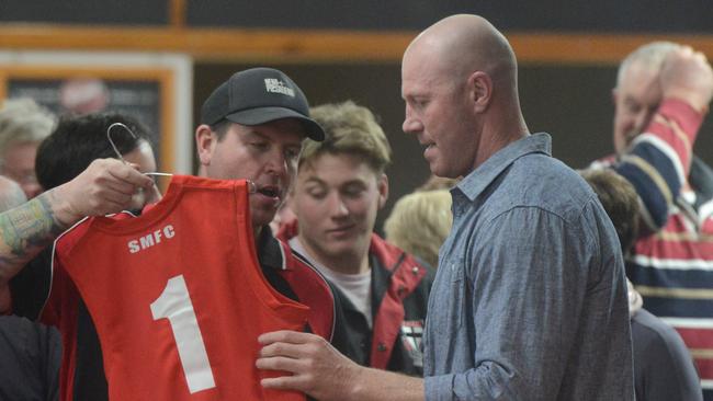 Hall signs a jersey on Saturday night at the South Australian country club.