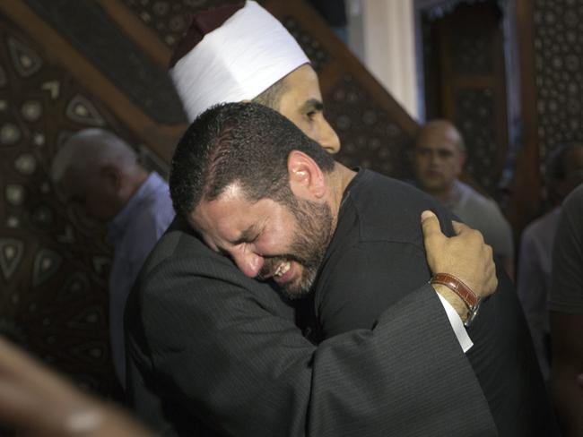 The Imam of al Thawrah Mosque, Samir Abdel Bary, gives condolences to Tarek Abu Laban, centre, who lost four relatives, all victims of EgyptAir plane crash.  Picture:  AP