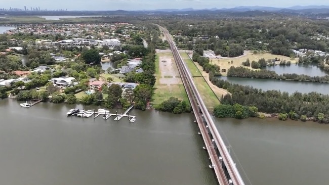 Drone footage showing the route for the Coomera Connector. The northern section will include a Coomera River crossing next to the existing heavy rail bridge.