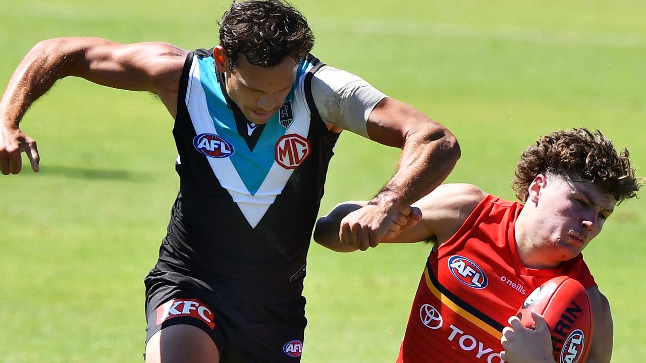 Steven Motlops bumps Crow Harry Schoenberg during the practice match on Saturday. Picture: Getty Images