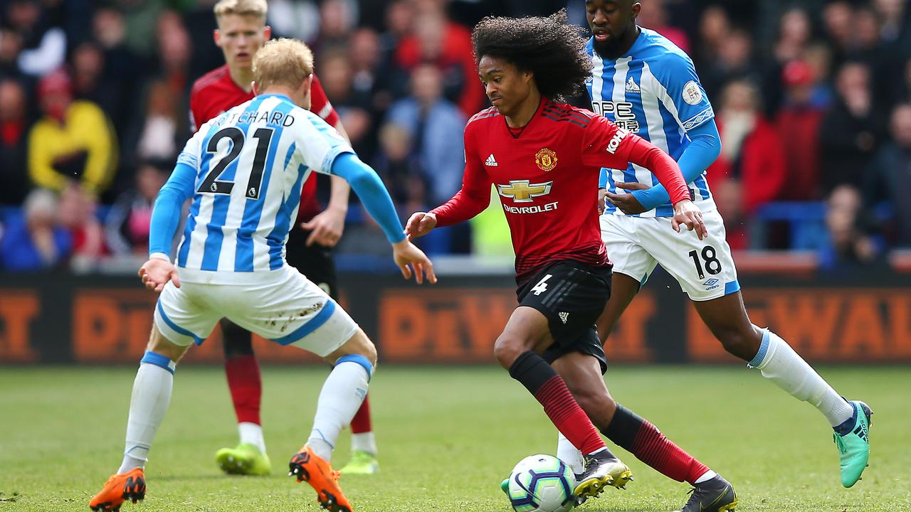 Manchester Tahith Chong  is challenged by Huddersfield Town Alex Pritchard at John Smith's Stadiumin Huddersfield. (Photo by Alex Livesey/Getty Images)