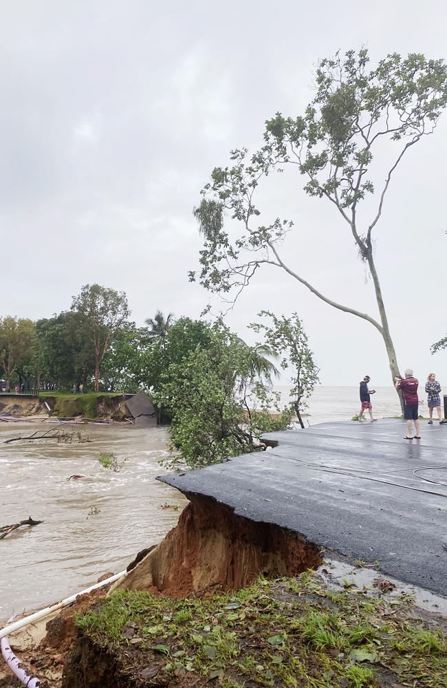 Locals get a snap of the shocking road damage along Casuriana St in Holloways Beach. Picture: Cairns Regional Council