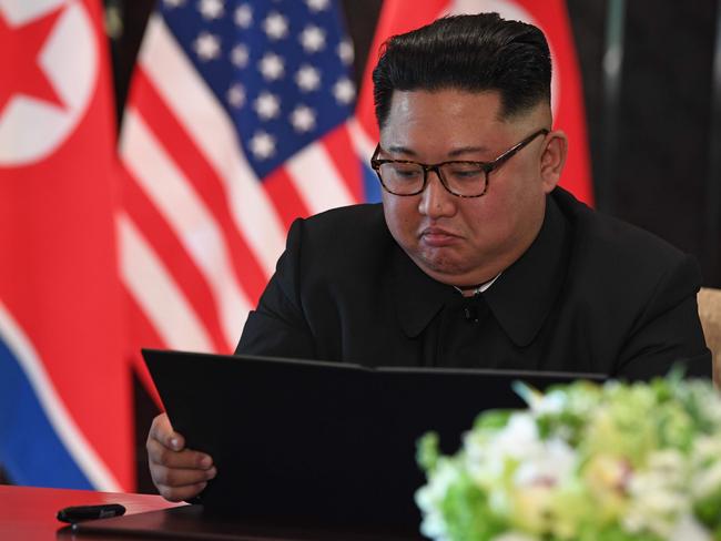 North Korea's leader Kim Jong-un reads the historic document at the signing ceremony.