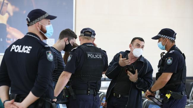 Police checking the Border passes of a family from Wollongong at Gold Coast Airport. Picture Glenn Hampson